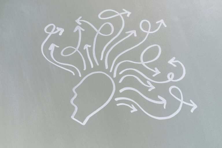 Home Chalk drawing of a head with swirling arrows represents mental activity and thought process.